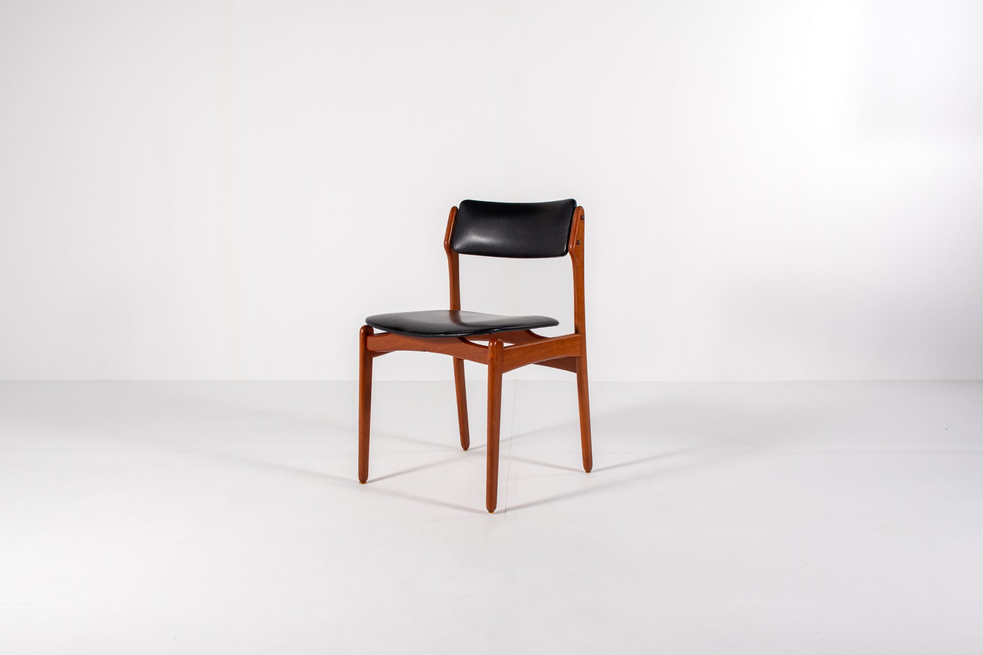 Vintage Danish dining chair in teak with black skai upholstery