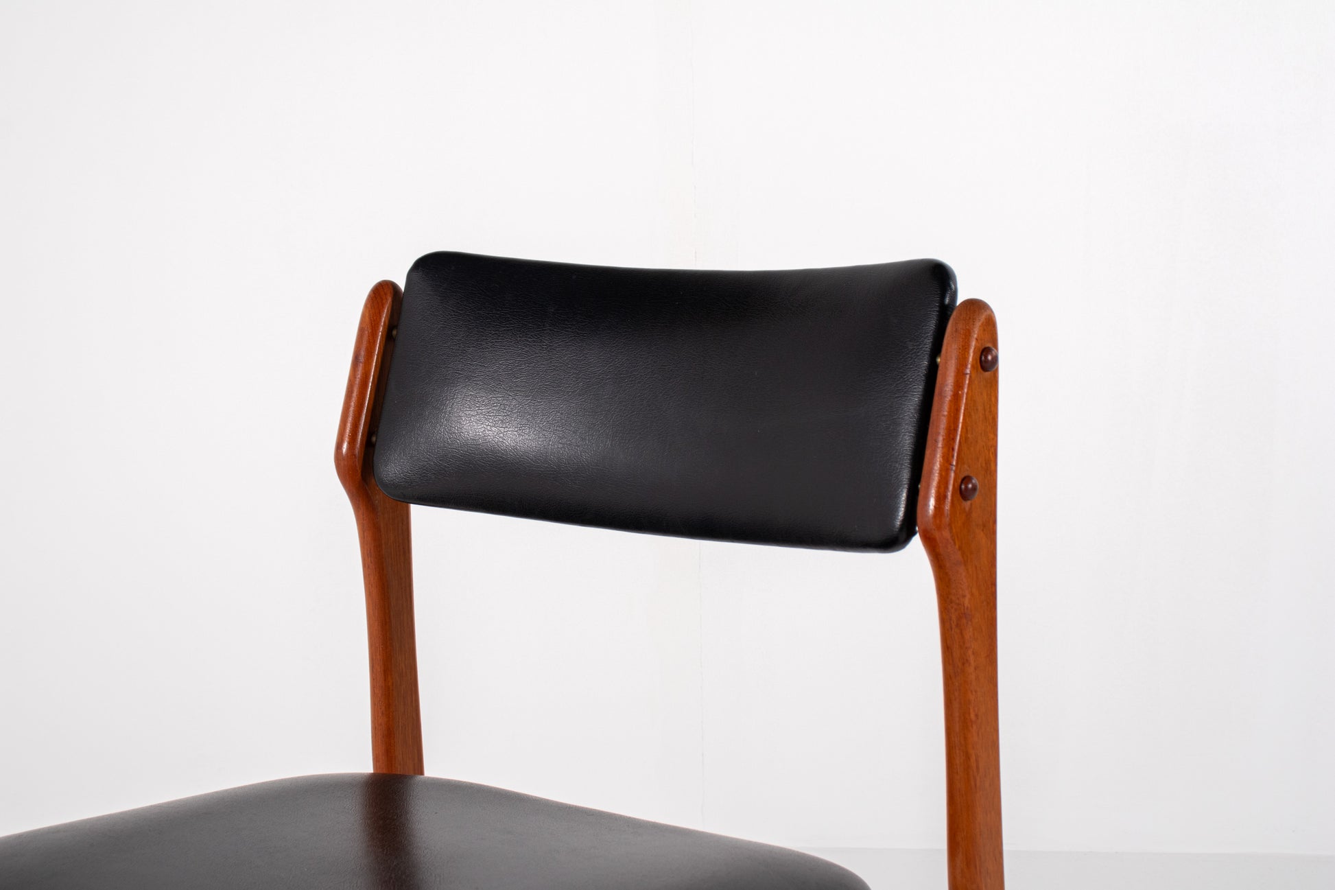 Vintage Danish dining chair in teak with black skai upholstery