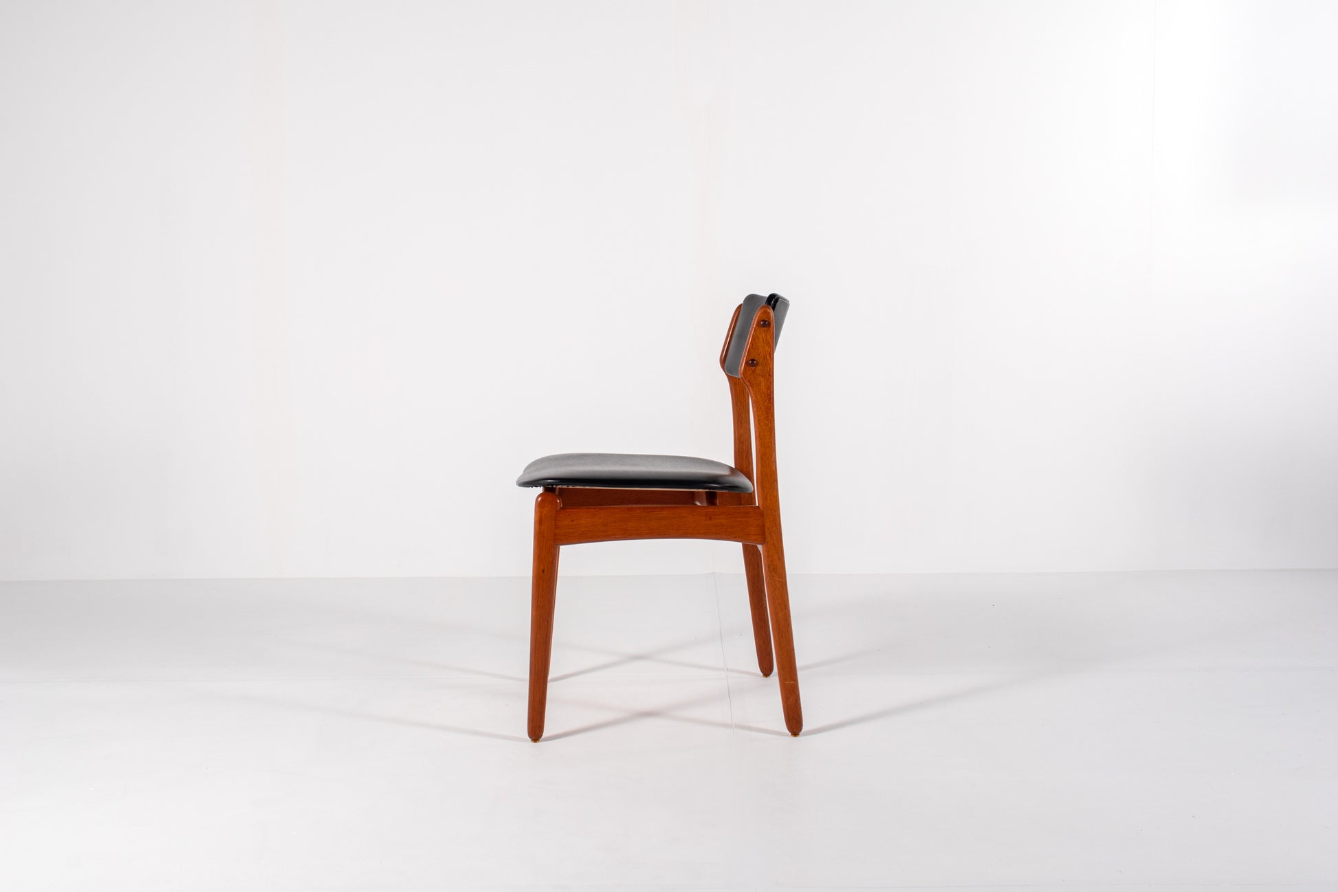 Vintage Danish dining chair in teak with black skai upholstery