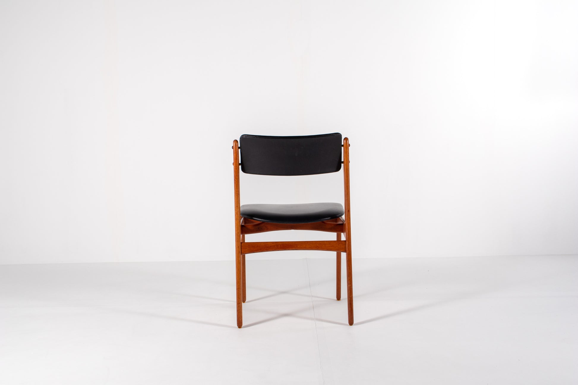 Vintage Danish dining chair in teak with black skai upholstery