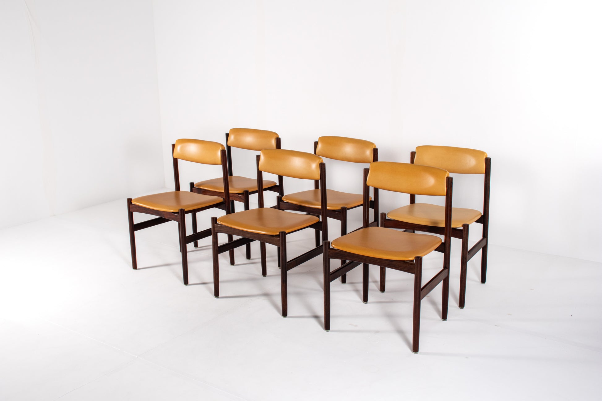 Danish dining chairs with rosewood frames and yellow skai upholstery