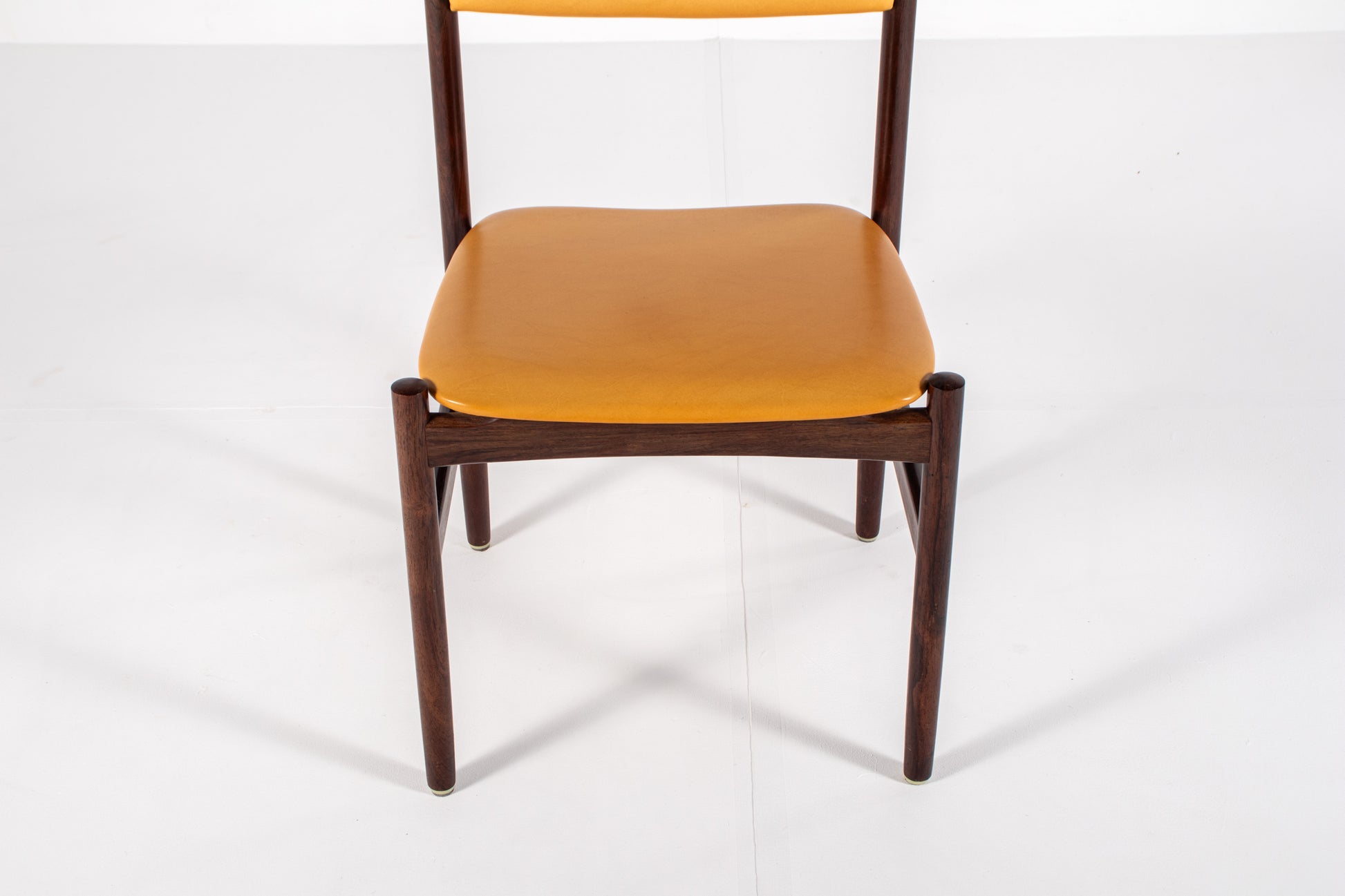 Danish dining chair with rosewood frames and yellow skai upholstery