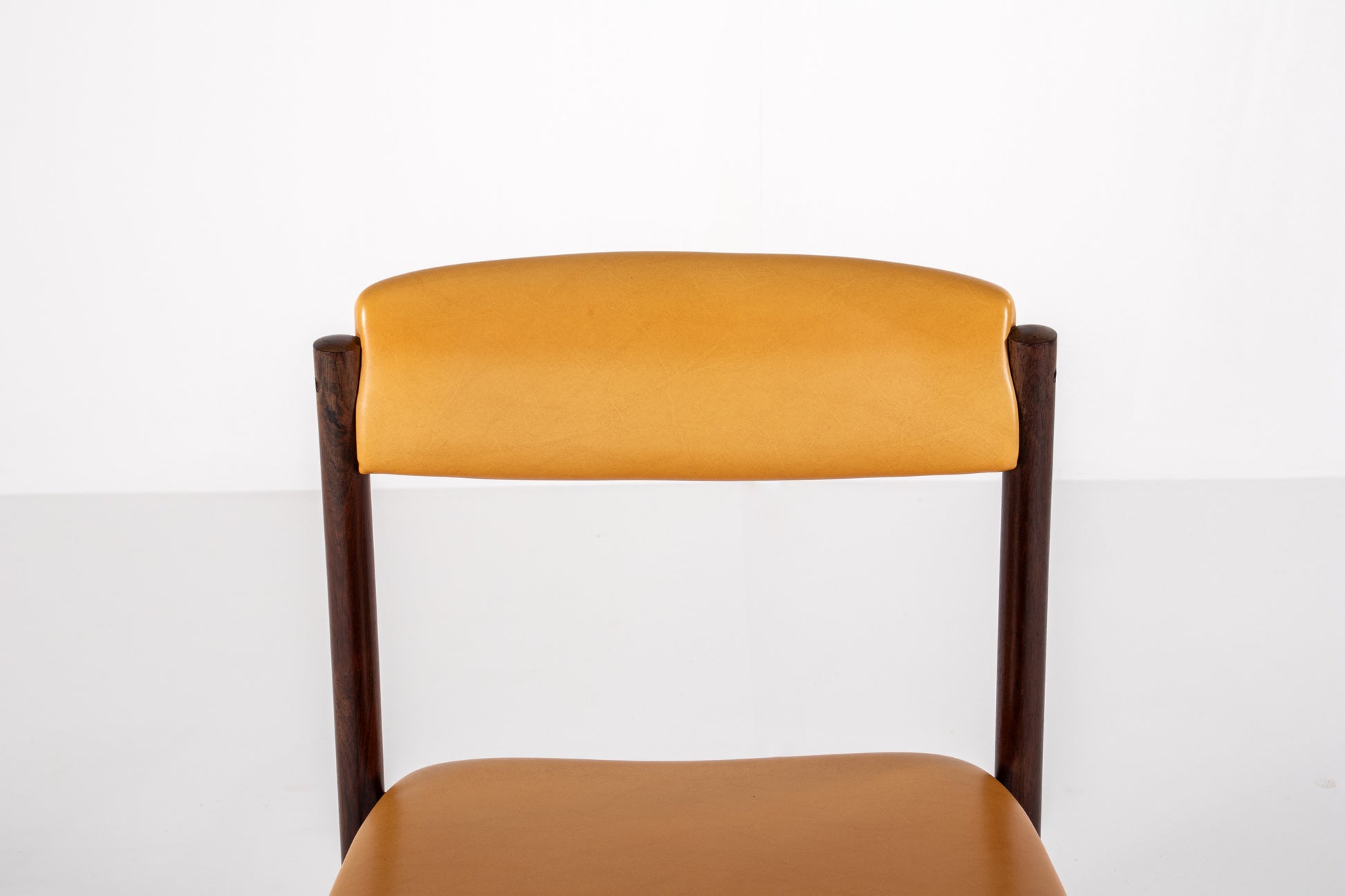 Danish dining chair with rosewood frames and yellow skai upholstery