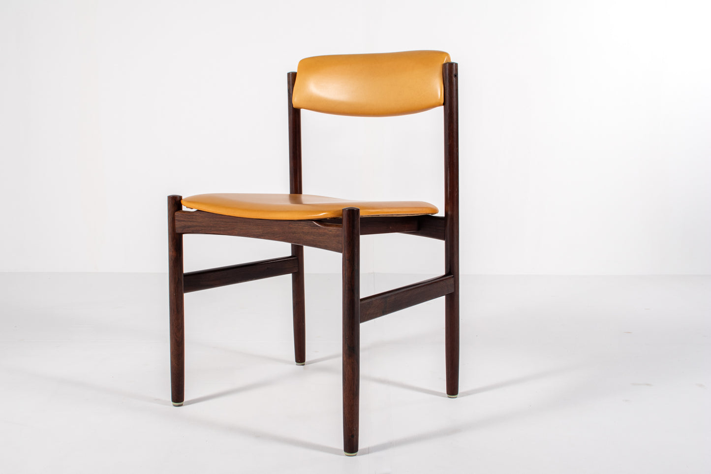 Danish dining chair with rosewood frames and yellow skai upholstery