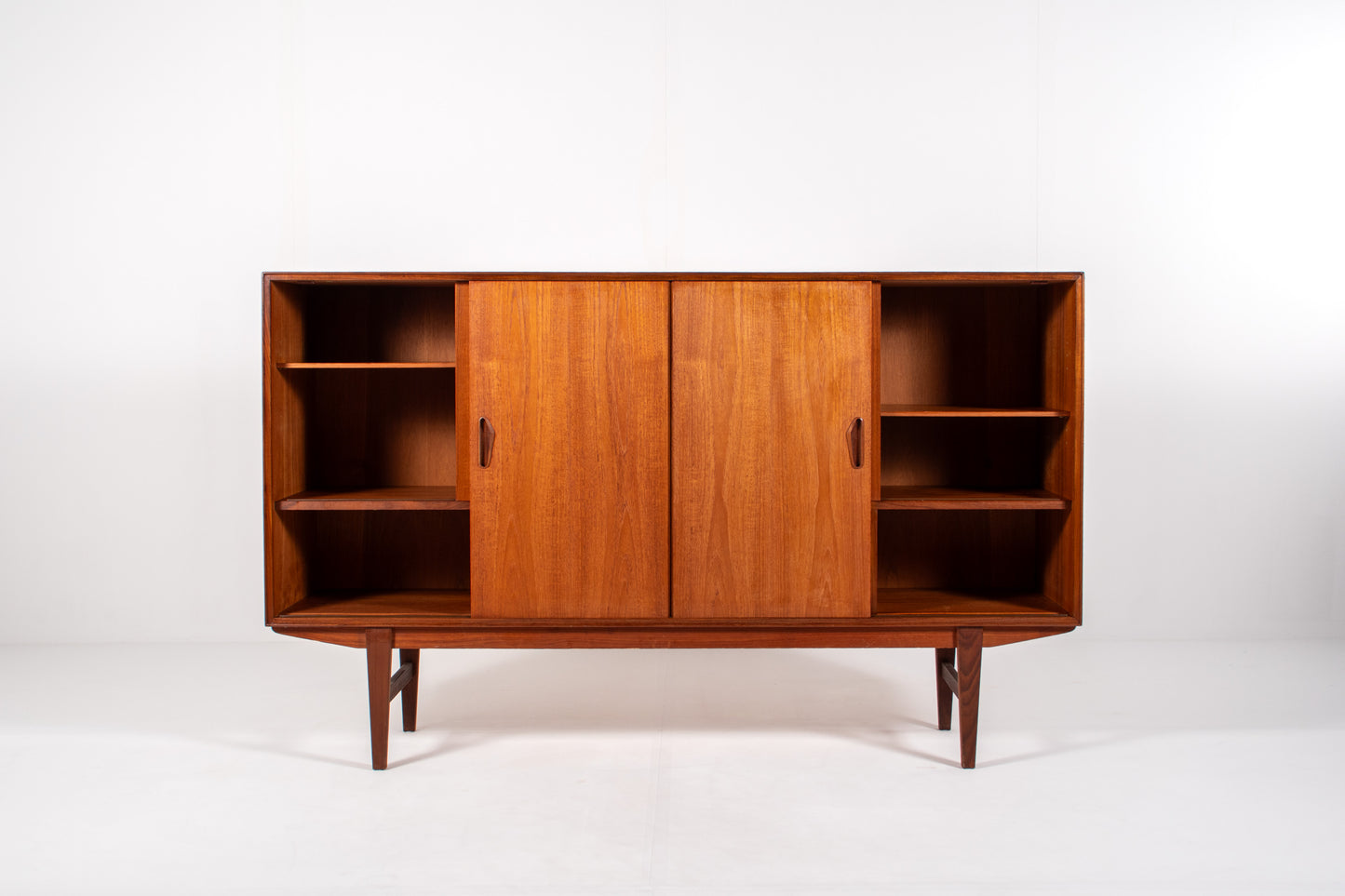 Interior view of Danish sideboard with sliding doors and shelving