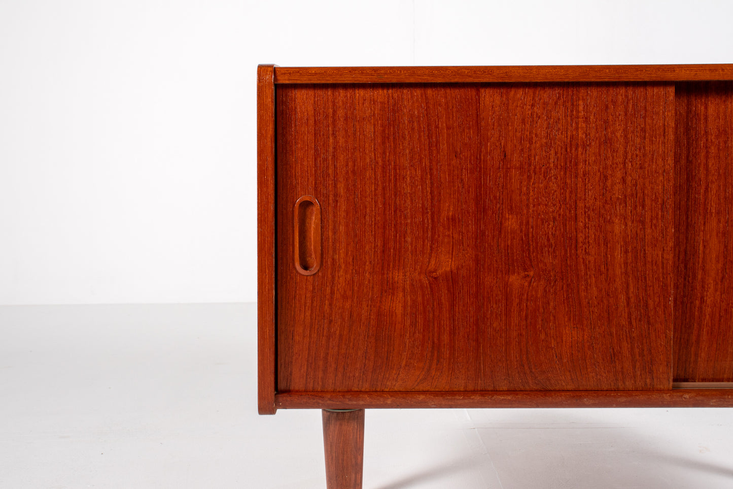 Detail of teak grain and craftsmanship on vintage cabinet