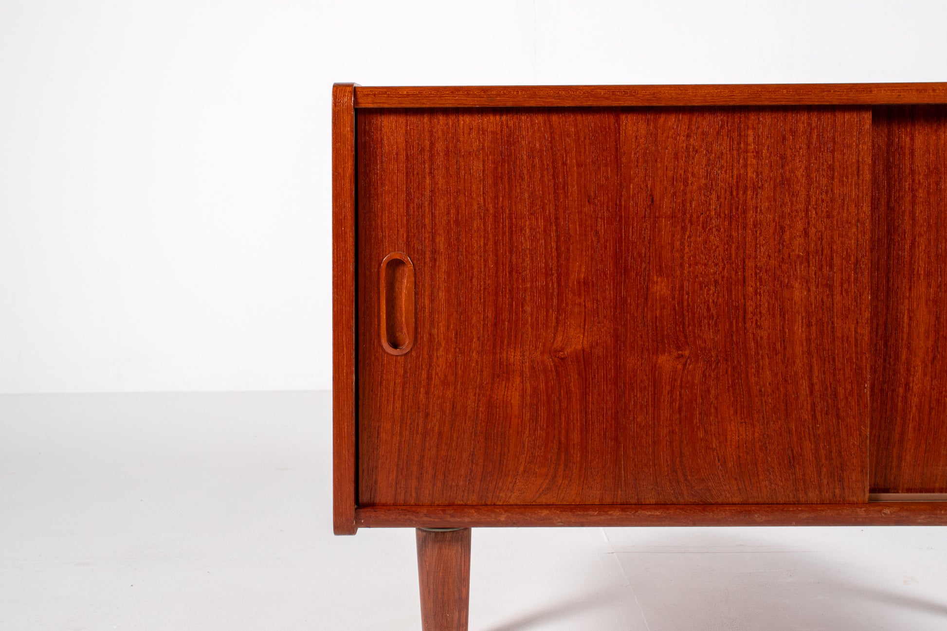 Detail of teak grain and craftsmanship on vintage cabinet