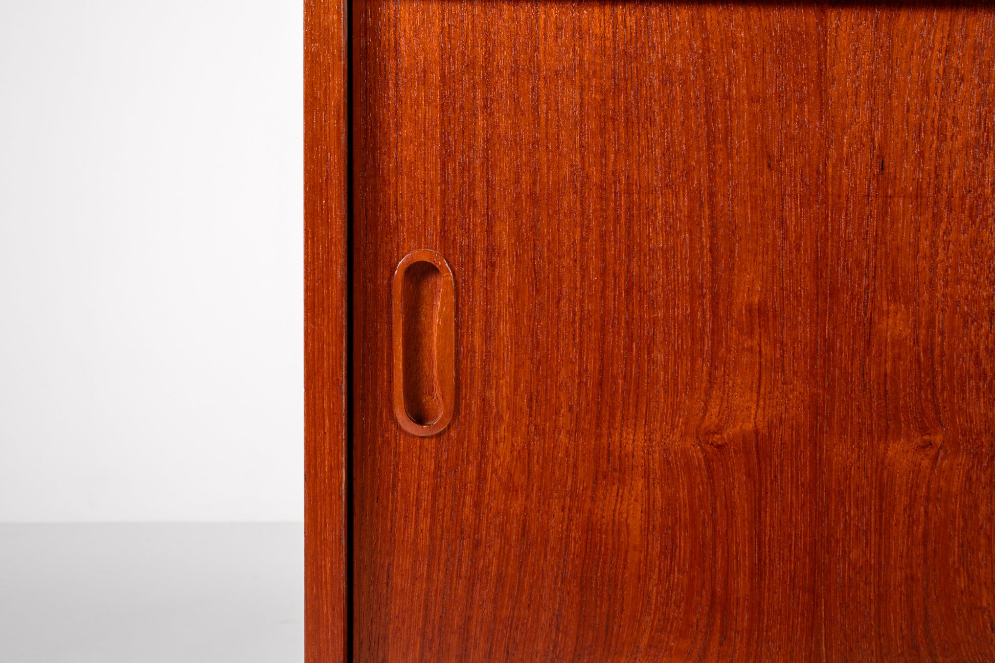 Detail of teak grain and craftsmanship on vintage cabinet