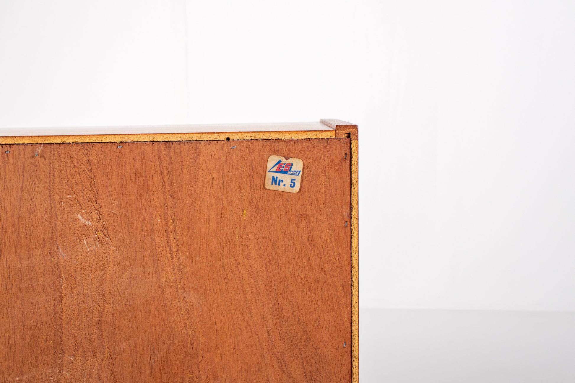 Mid-century modern teak cabinet with sliding doors, back view and manufacturer's label