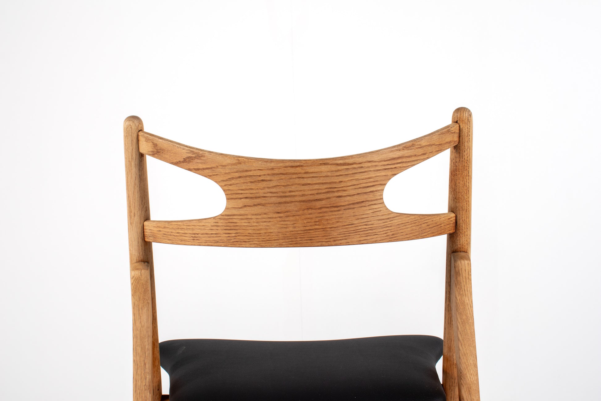 Solid oak Sawbuck chairs with black skai upholstery