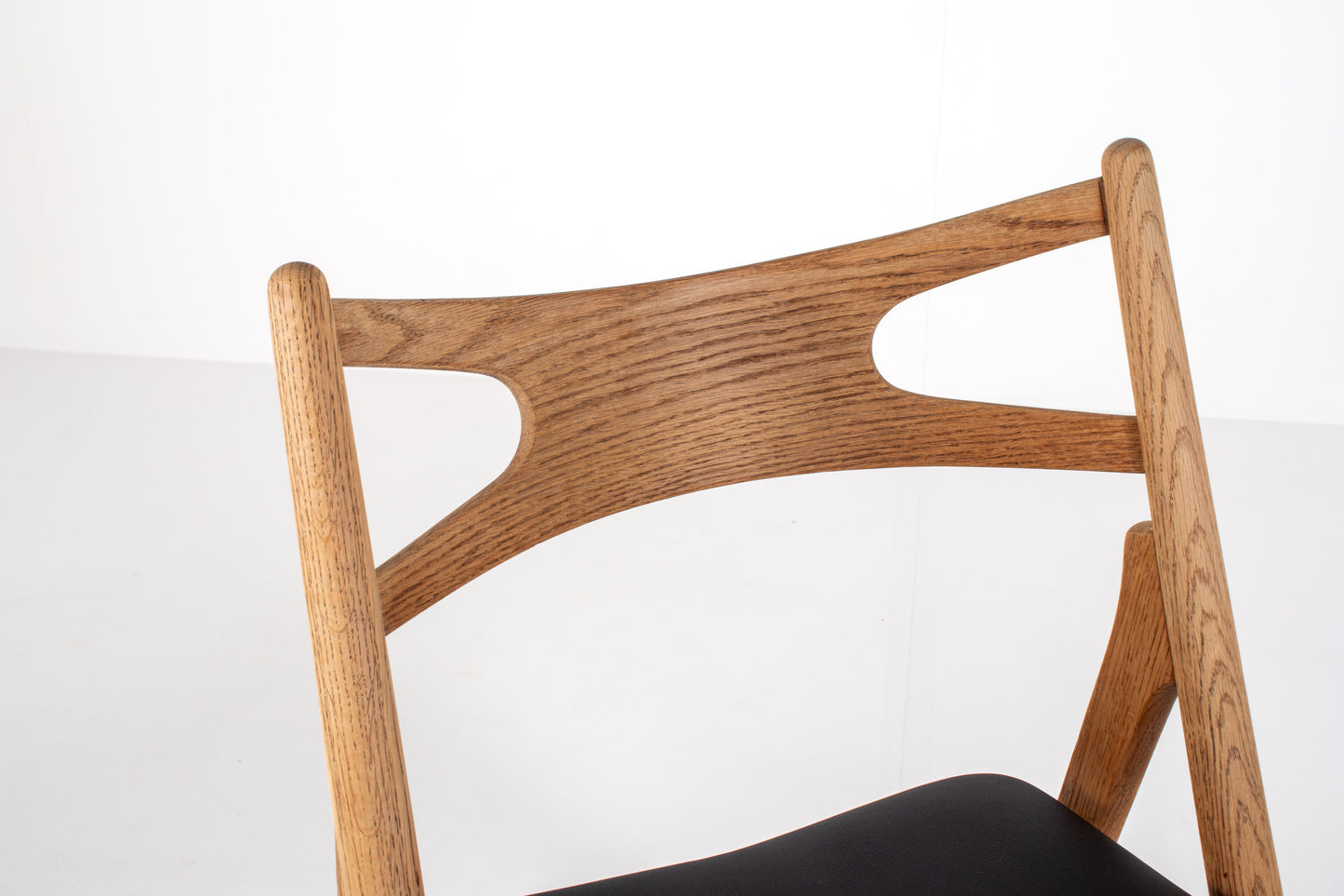 Solid oak Sawbuck chairs with black skai upholstery
