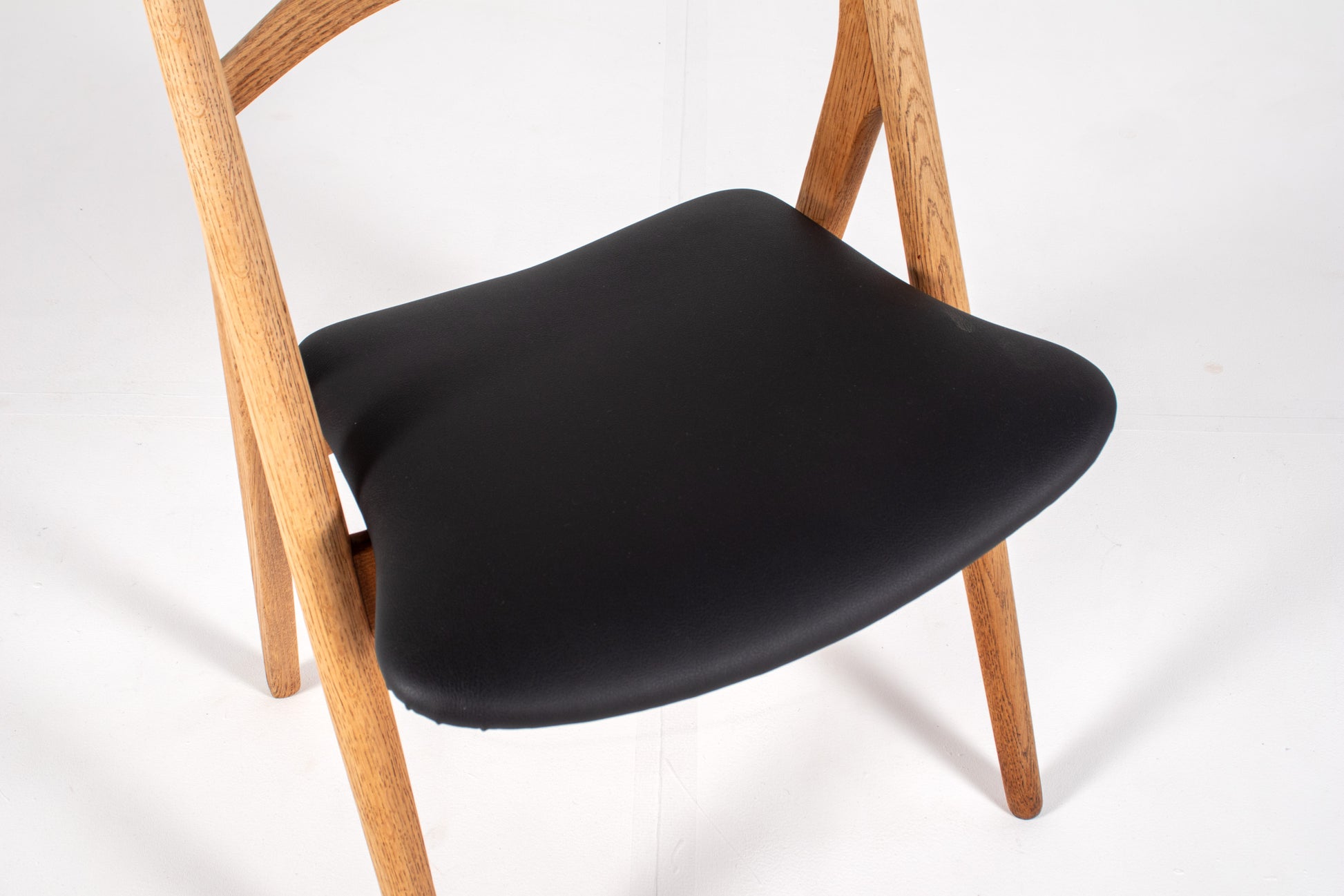 Solid oak Sawbuck chairs with black skai upholstery
