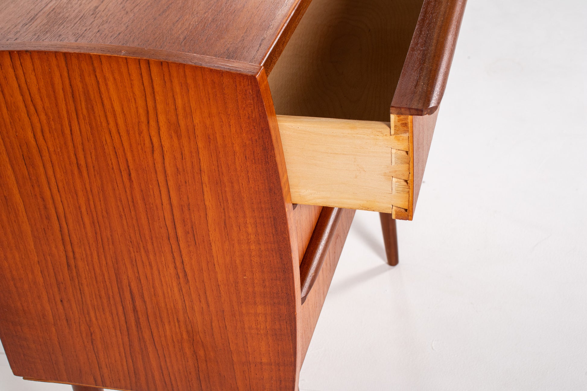 Teak wood grain detail on vintage Danish drawer unit