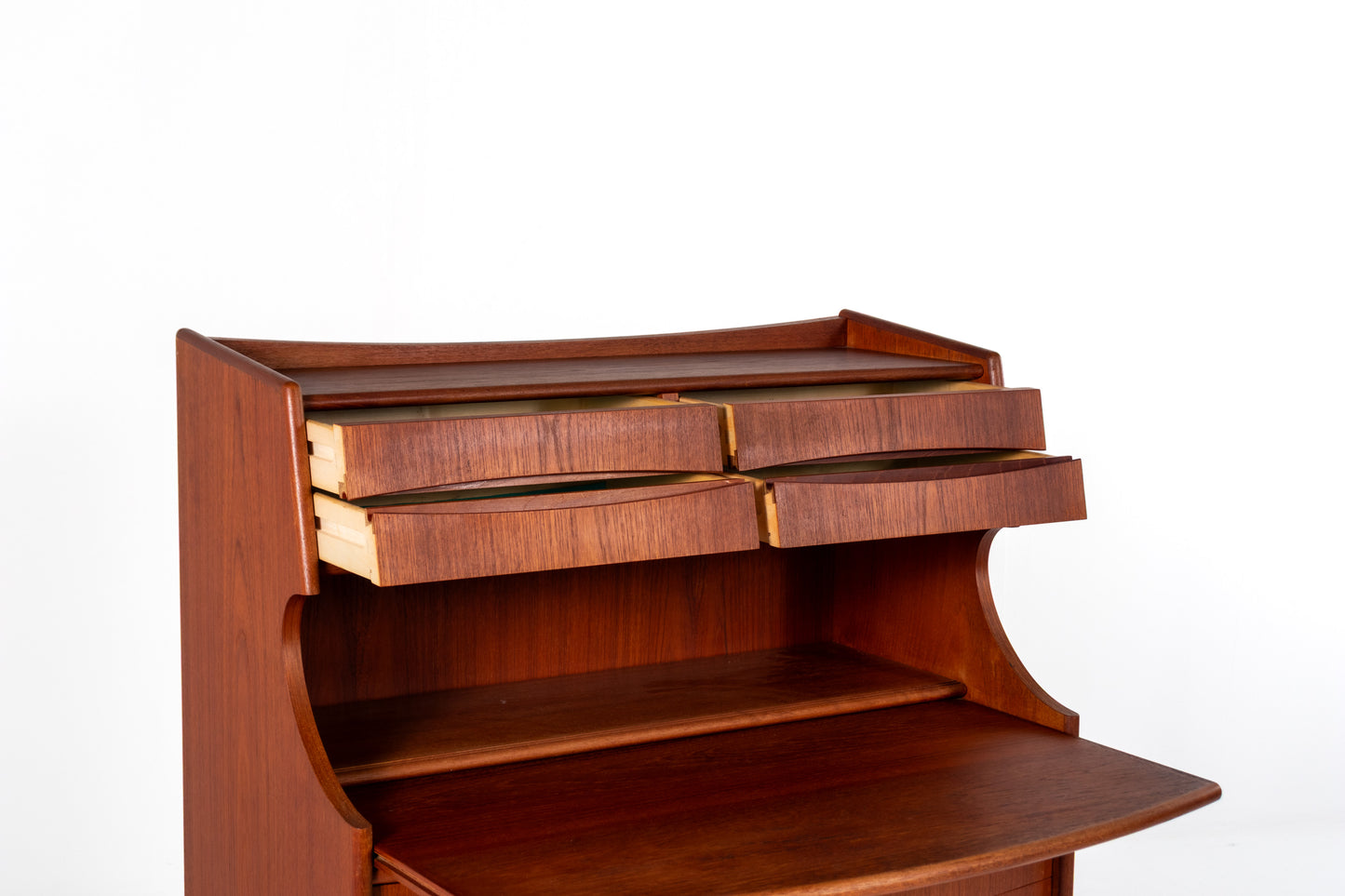A close-up of a reddish-brown wooden desk or secretary with multiple drawers and a slanted writing surface, photographed against a plain white background.