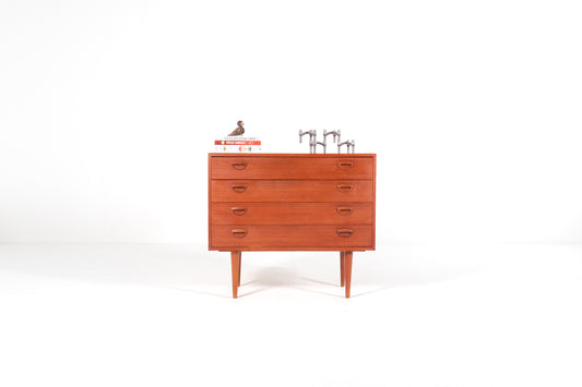 A mid-century modern wooden chest of drawers with five drawers by Kai Kristiansen, shown against a plain white studio background. 