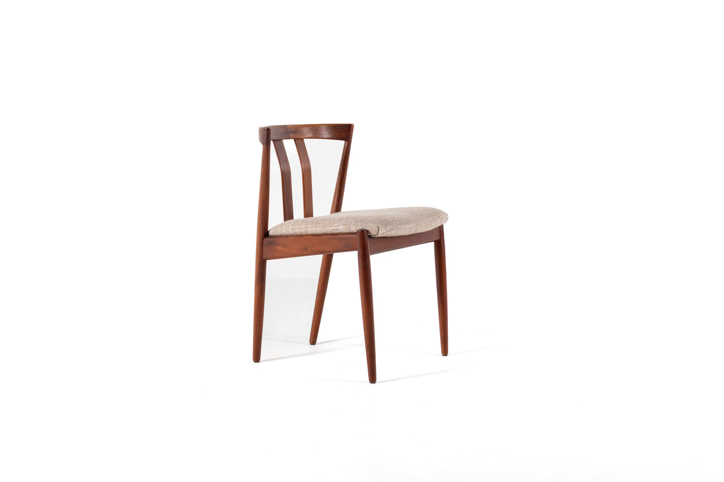 A mid-century modern wooden dining chair with a warm brown frame and a light beige upholstered seat, shown against a plain white background.