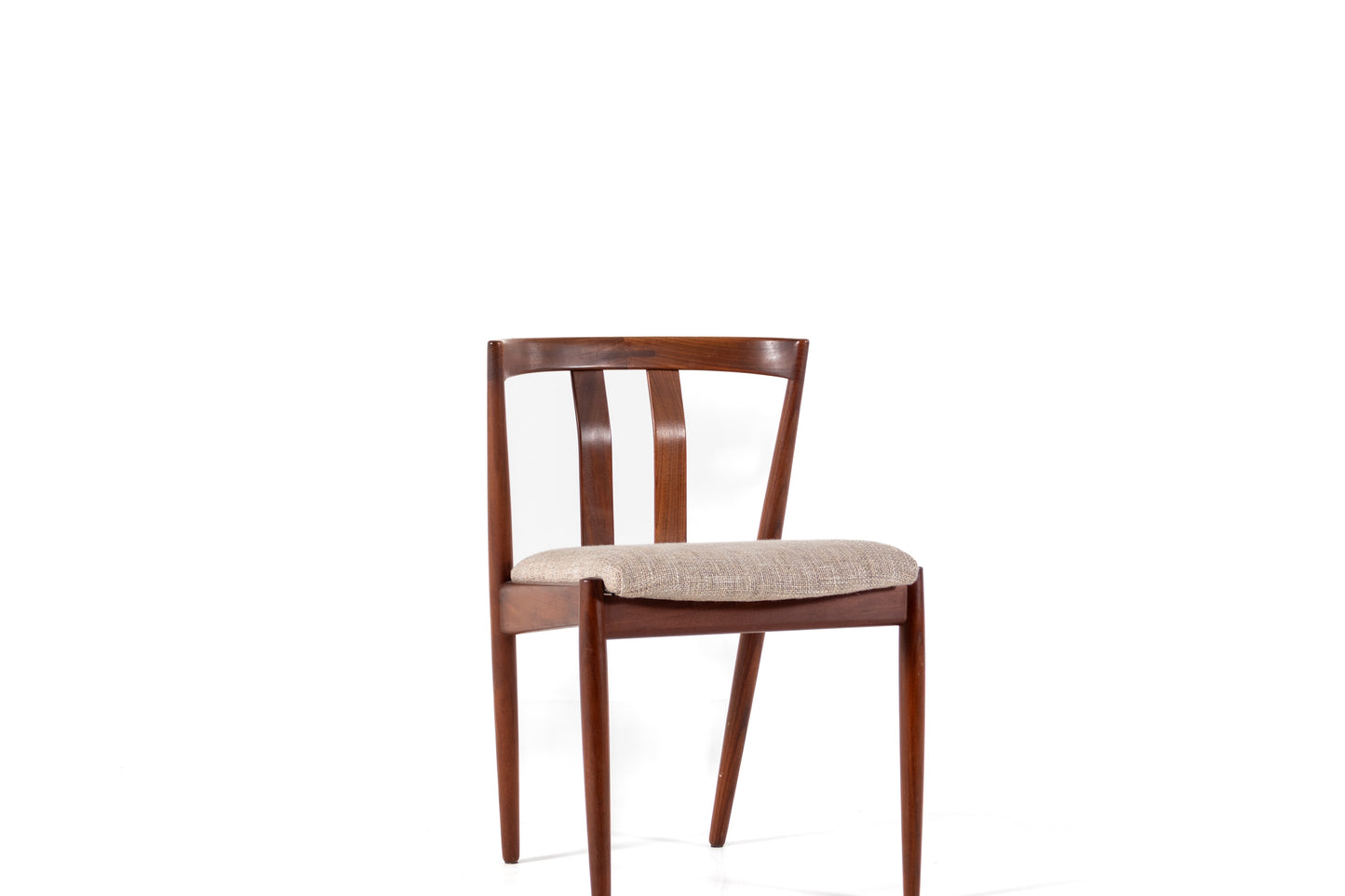 A mid-century modern wooden dining chair with a warm brown wood frame and a light beige textured upholstered seat, shown against a solid white background.