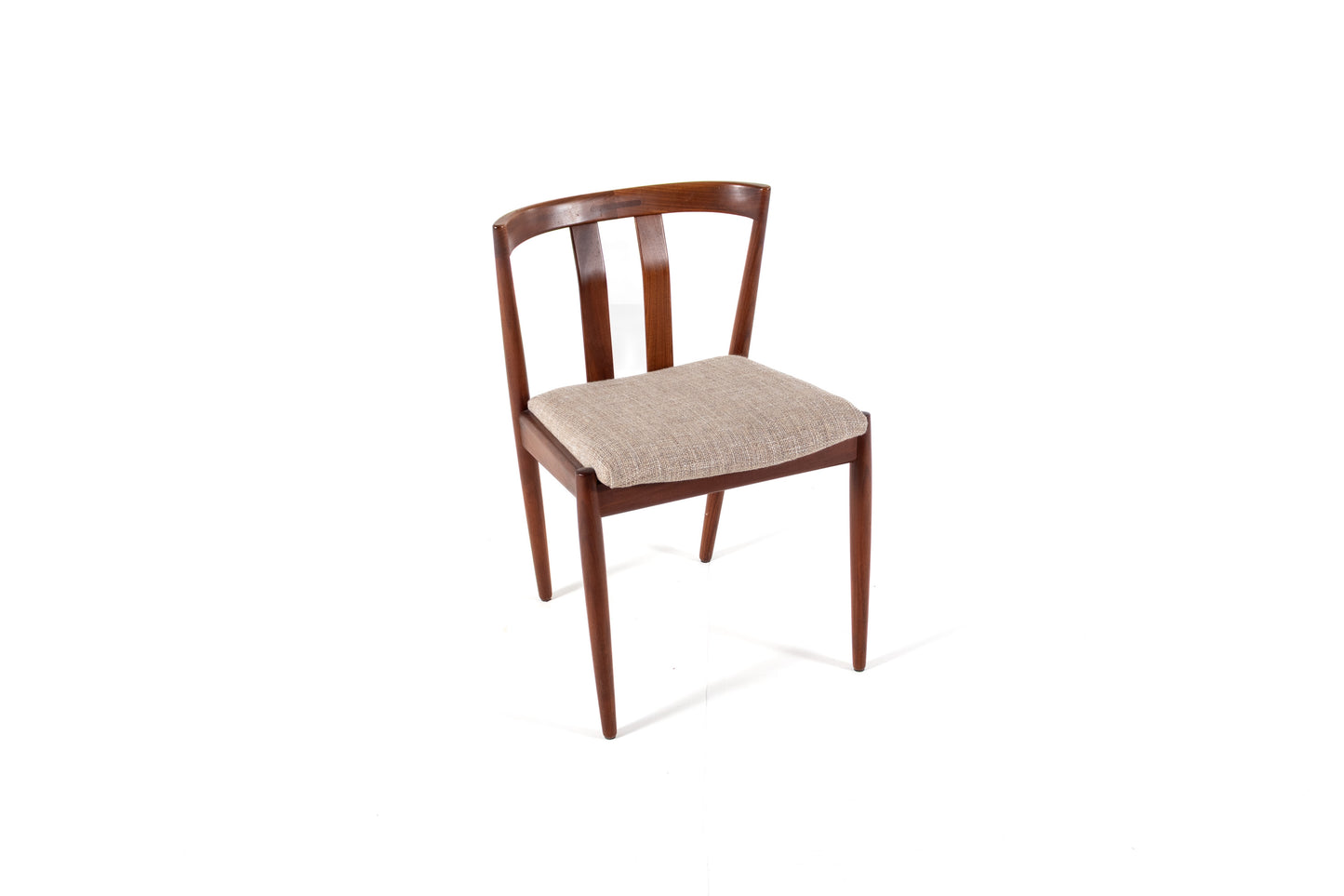 A mid-century modern wooden dining chair with a curved backrest, four tapered legs, and a light beige textured fabric seat cushion, shown on a plain white background.