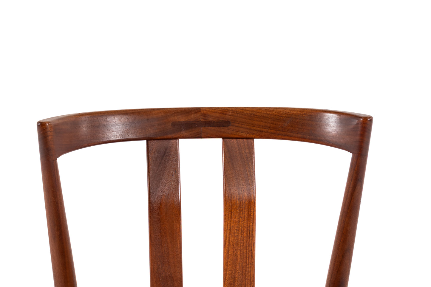Close-up of a wooden chair back with a curved top rail and three vertical slats, shown against a plain white background.
