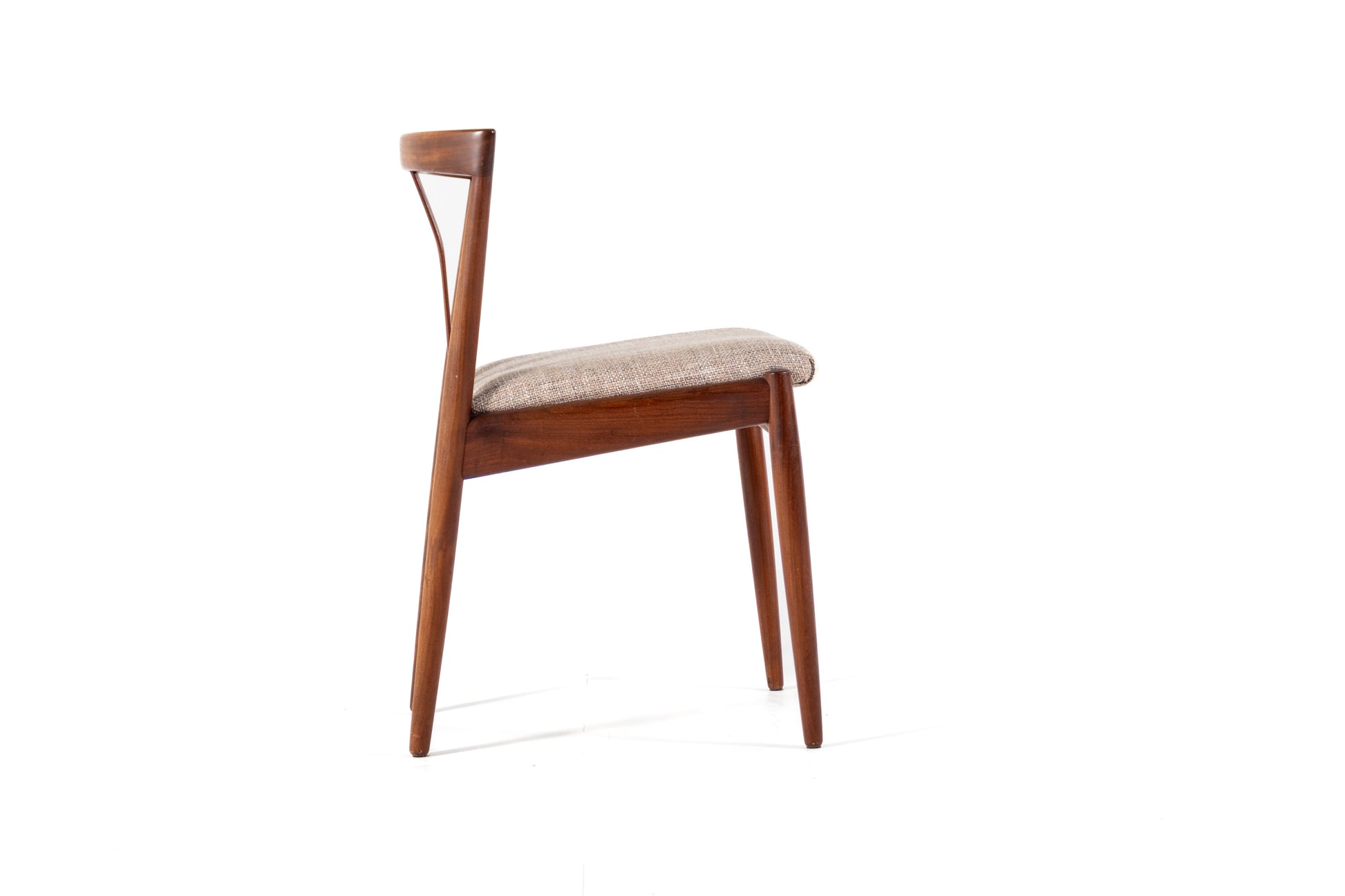 A mid-century modern wooden dining chair with a curved backrest, medium brown wood frame, and a light beige textured fabric seat cushion, shown against a plain white background.