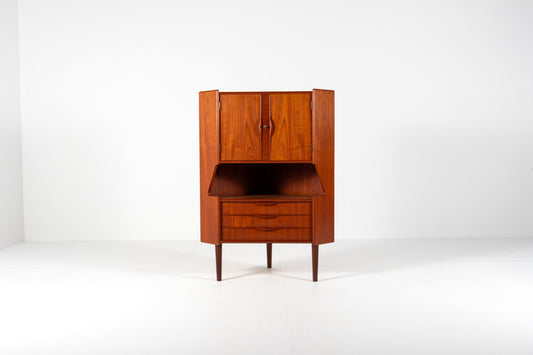 A mid-century modern wooden cabinet with a warm reddish-brown finish, featuring a closed upper cabinet, an open middle section, and two drawers below, set against a plain white studio background.