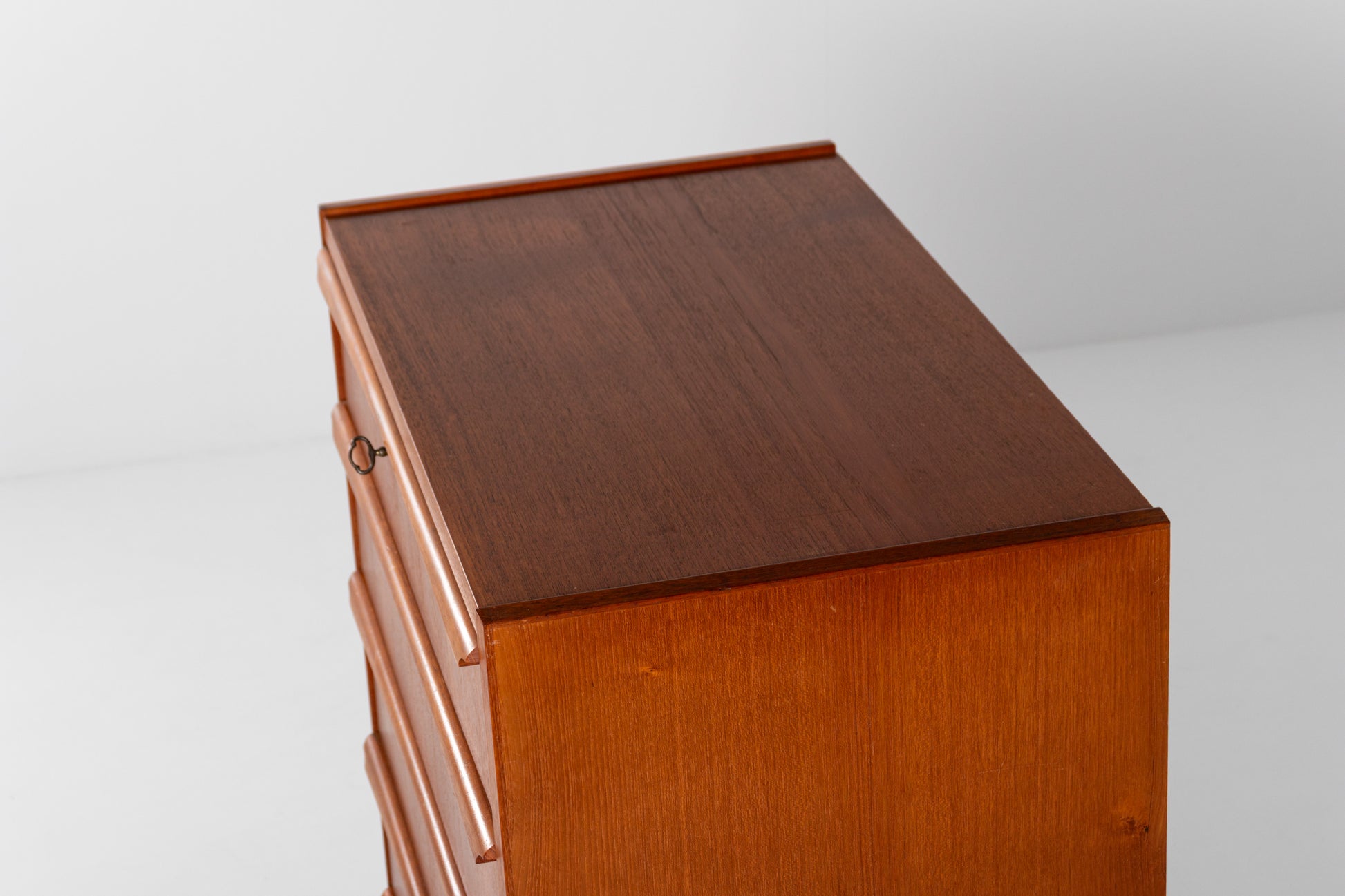 Warm teak grain on a Mid-Century Danish chest of drawers