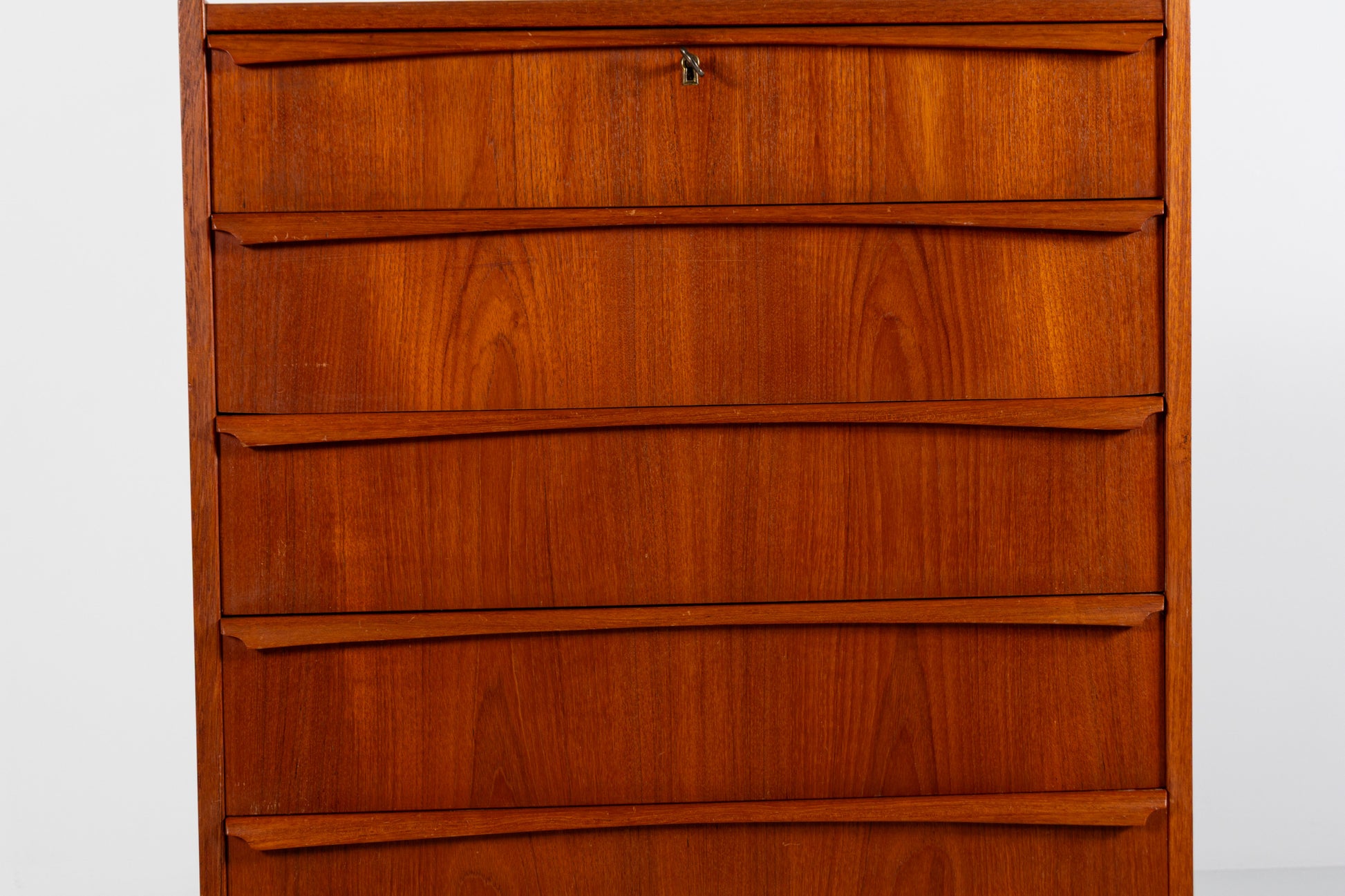Warm teak grain on a Mid-Century Danish chest of drawers