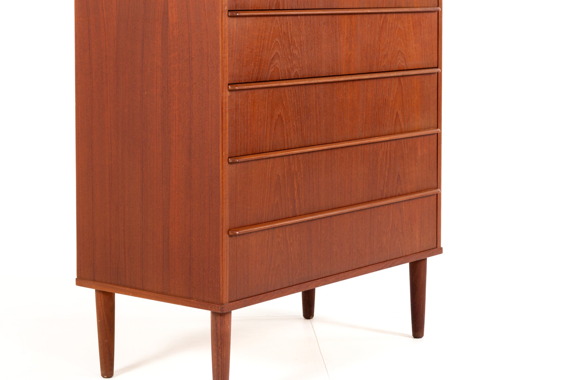 Danish teak tallboy with recessed drawer handles.
