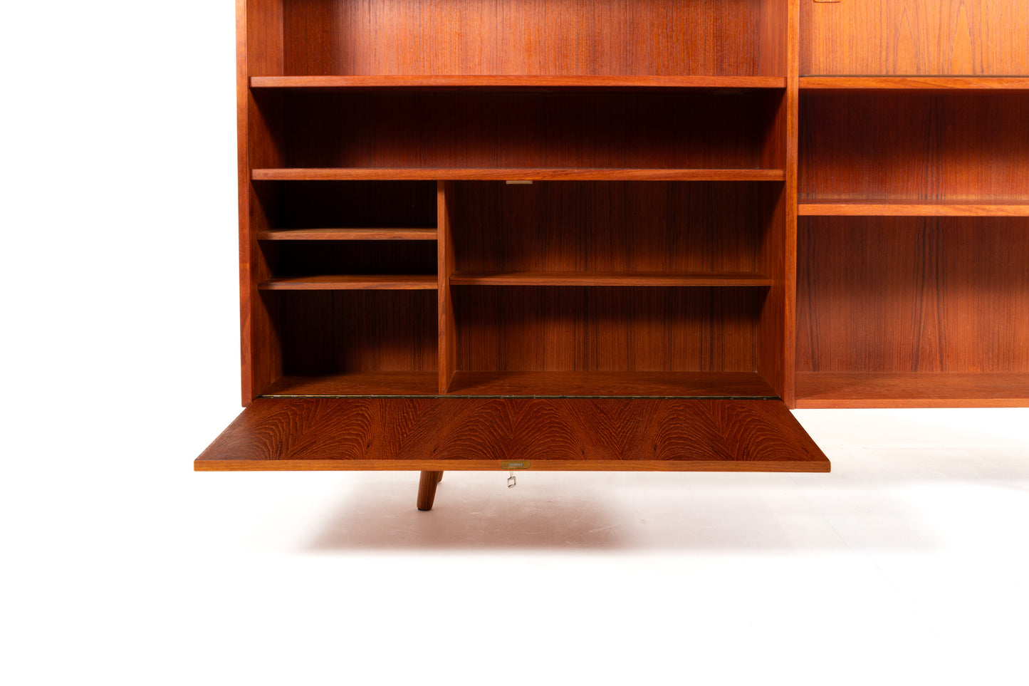 Lockable drop-down storage compartment in Danish bookcase