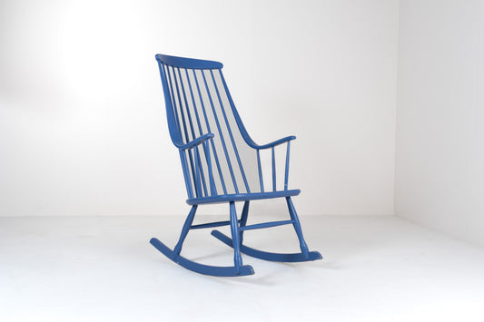 Front view of a vintage 1960s Grandessa rocking chair by Lena Larsson for Nesto in blue painted wood with a tall Windsor-style spindle back and curved armrests.