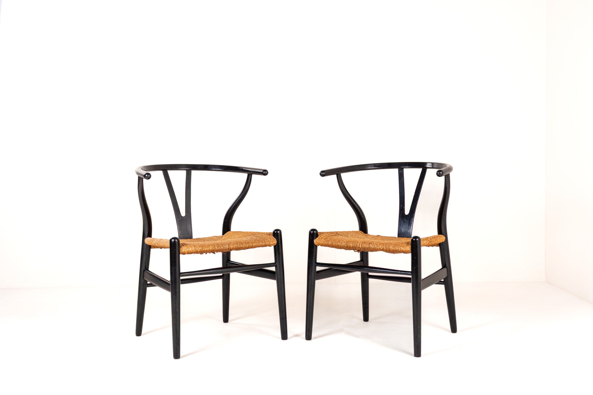 Pair of Hans Wegner CH24 Wishbone Chairs in black with paper cord seats