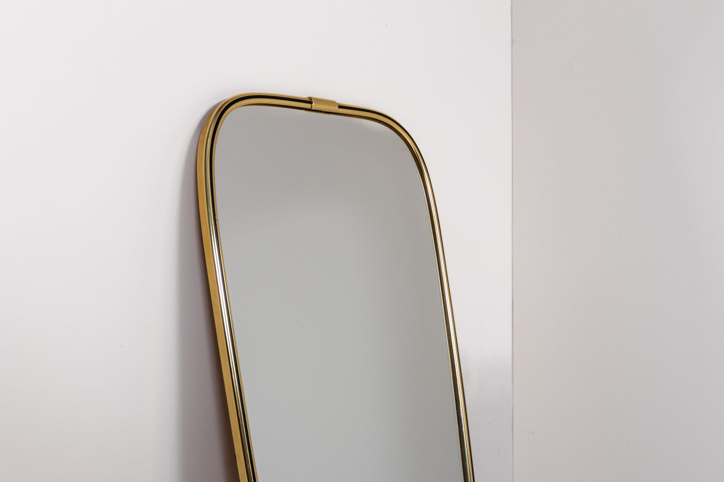 Vintage mid-century wall mirror with elongated brass frame