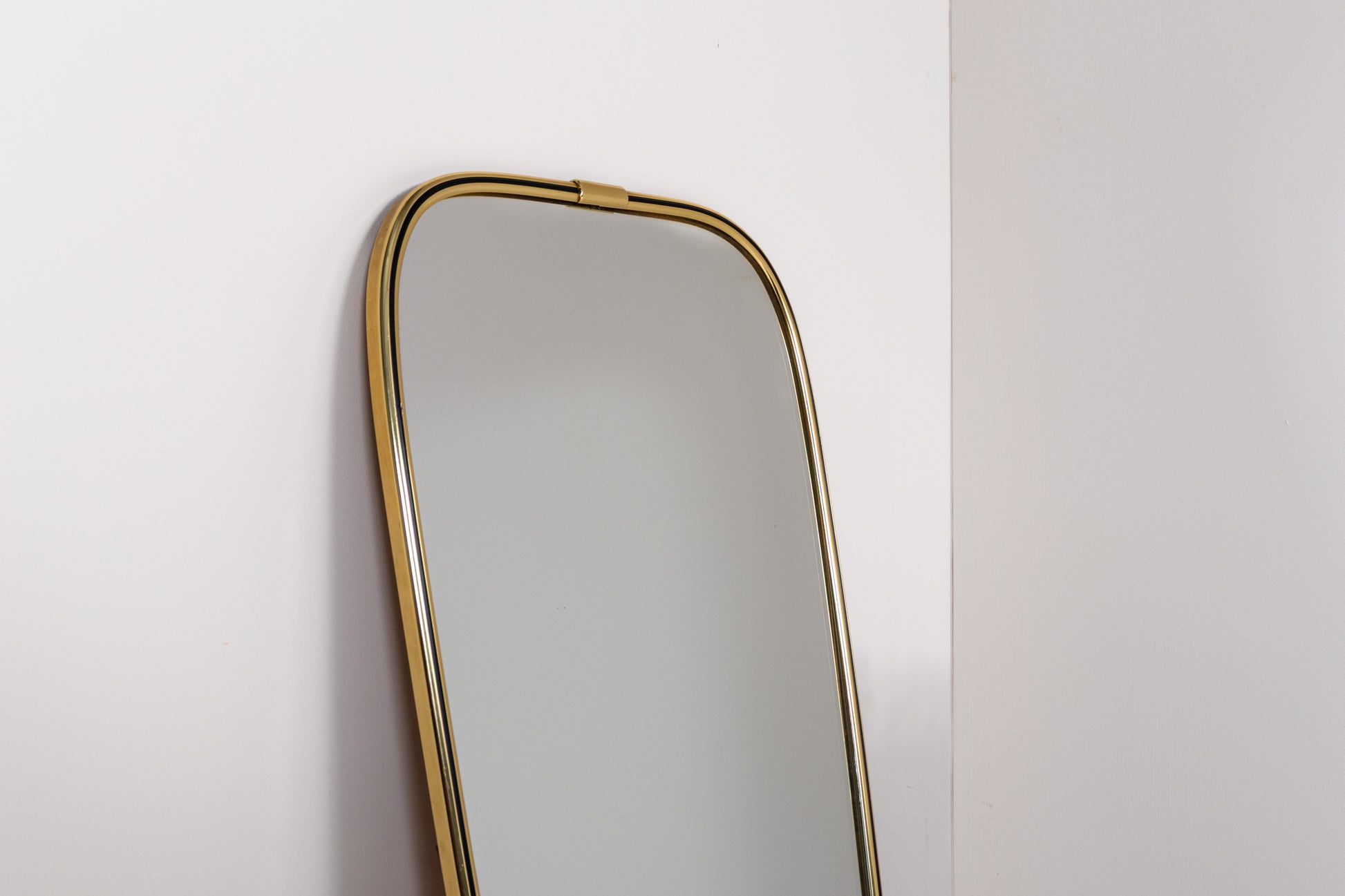 Vintage mid-century wall mirror with elongated brass frame