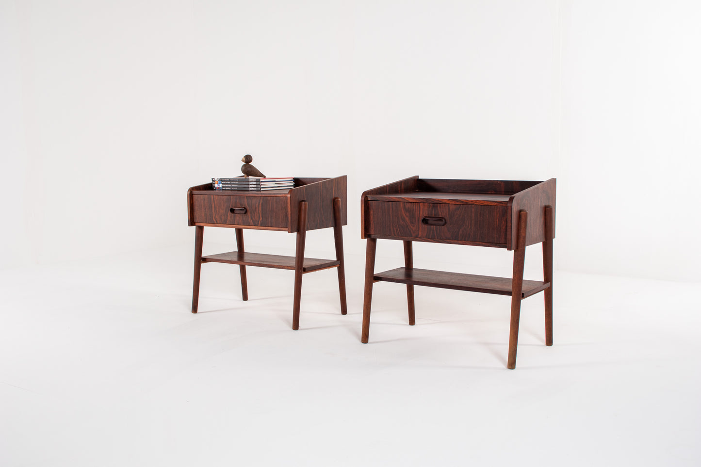 1960s mid-century bedside tables in rosewood with sculpted handles and lower storage shelf