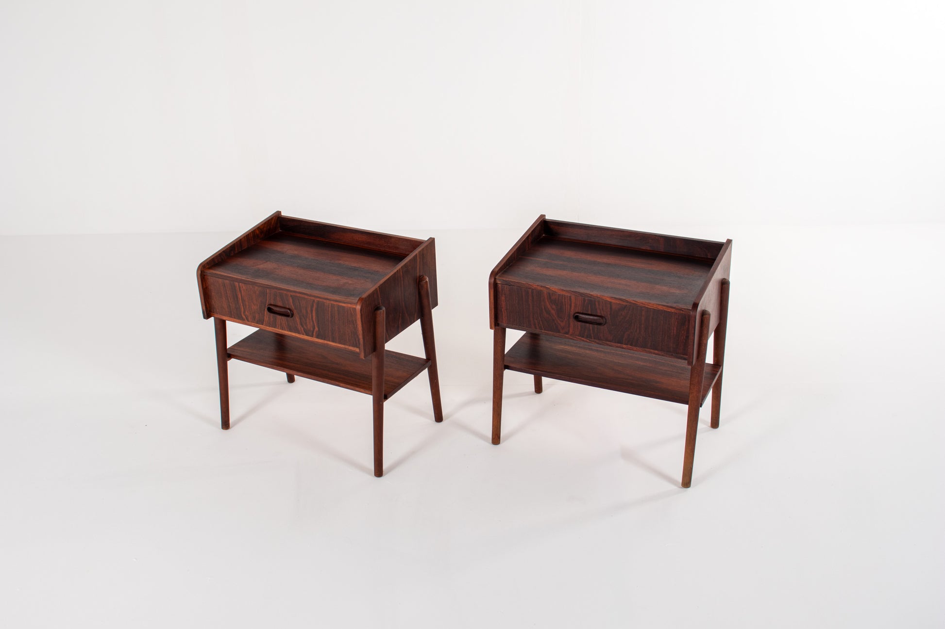 Rosewood Danish modern nightstands with drawer storage and tapered legs