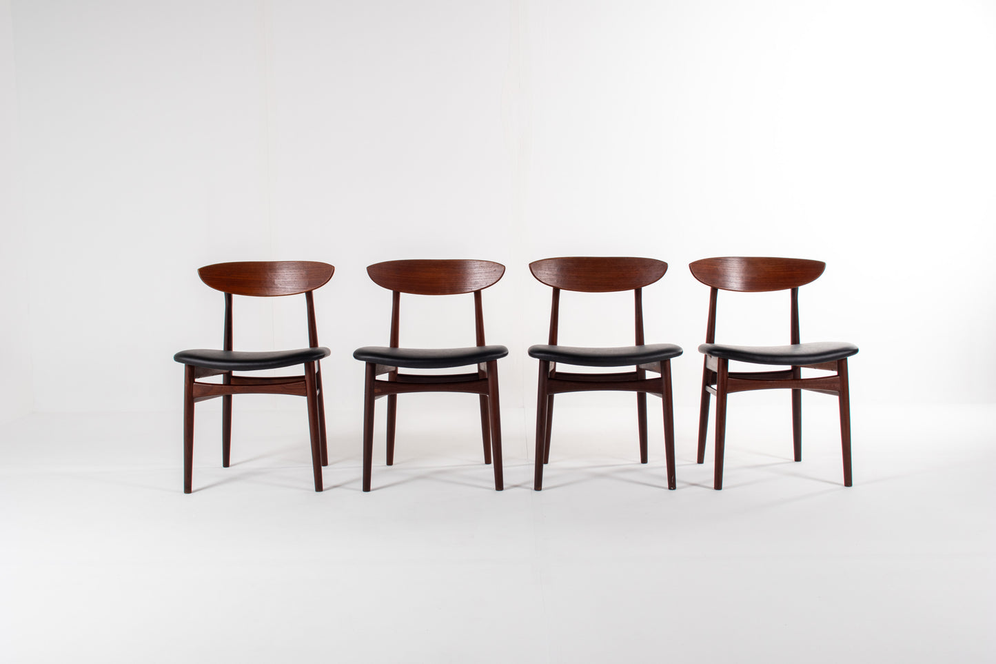 Set of four Danish mid-century modern teak dining chairs with black skai seats