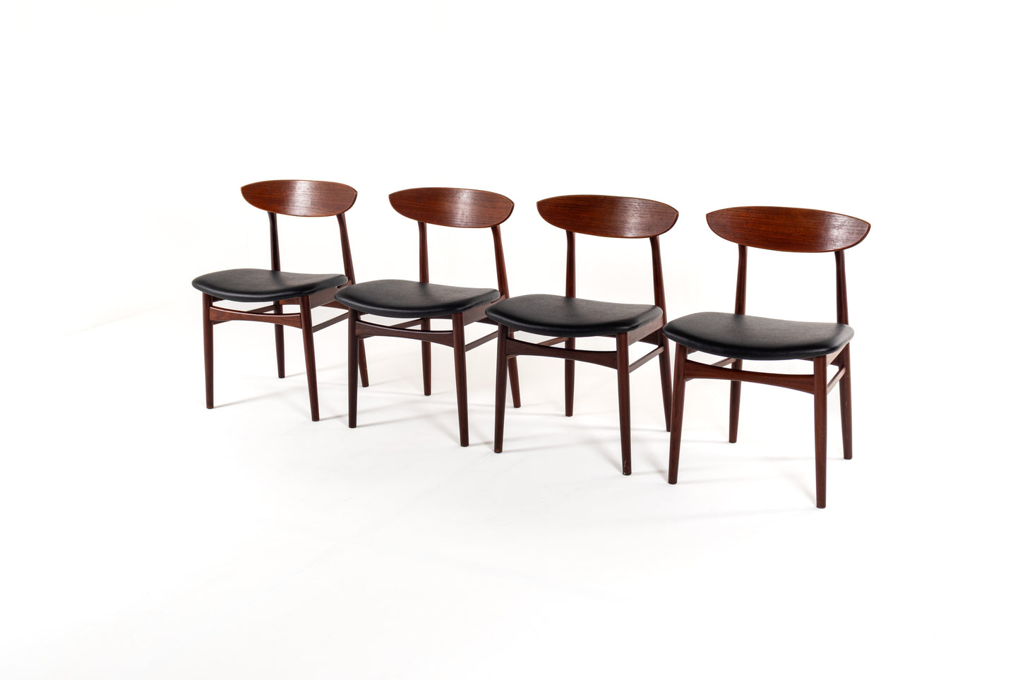 Danish modern dining chairs from the 1960s with curved teak backrests and black upholstery