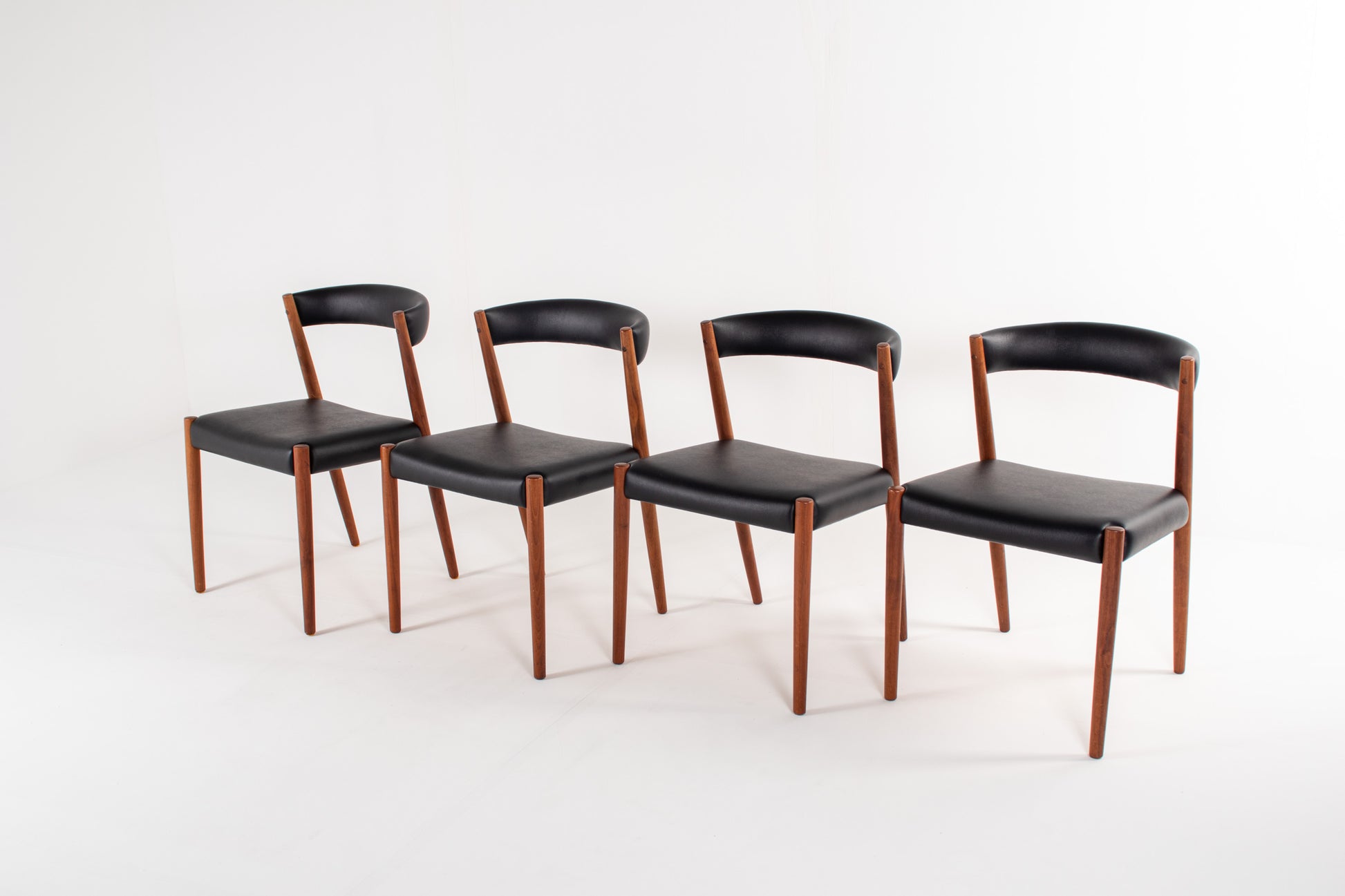 Danish modern teak dining chairs with black skai upholstery