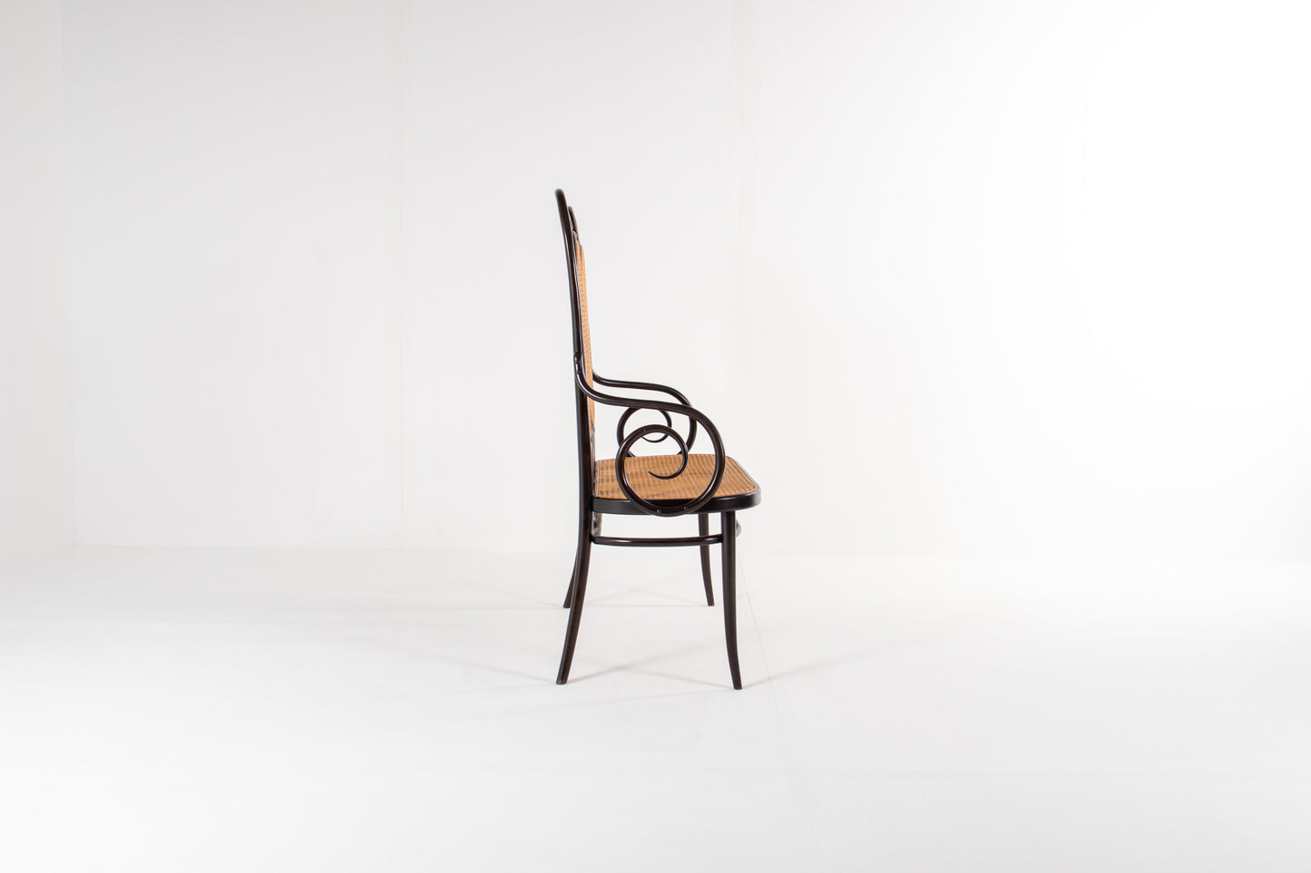 Side view of Thonet bentwood bench with curved arms