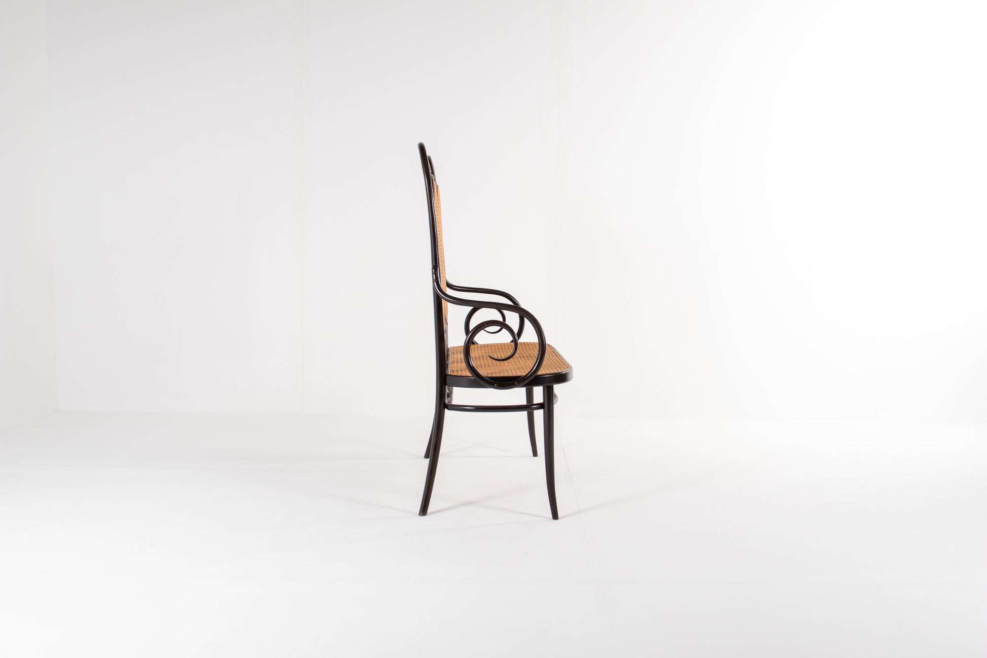 Side view of Thonet bentwood bench with curved arms