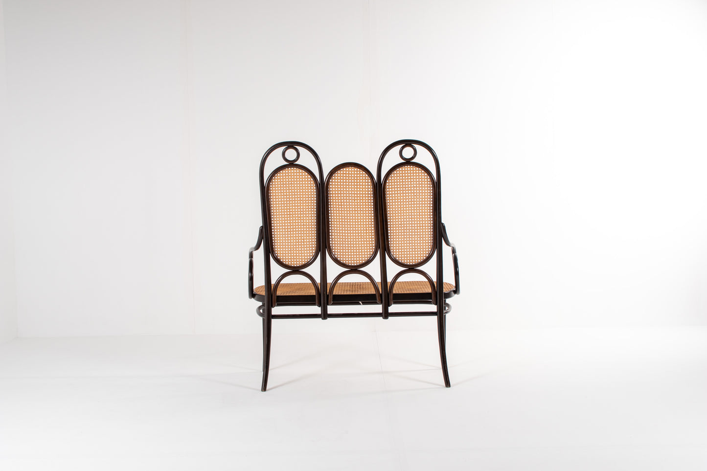 Bentwood bench with scroll arms and decorative rings, Thonet