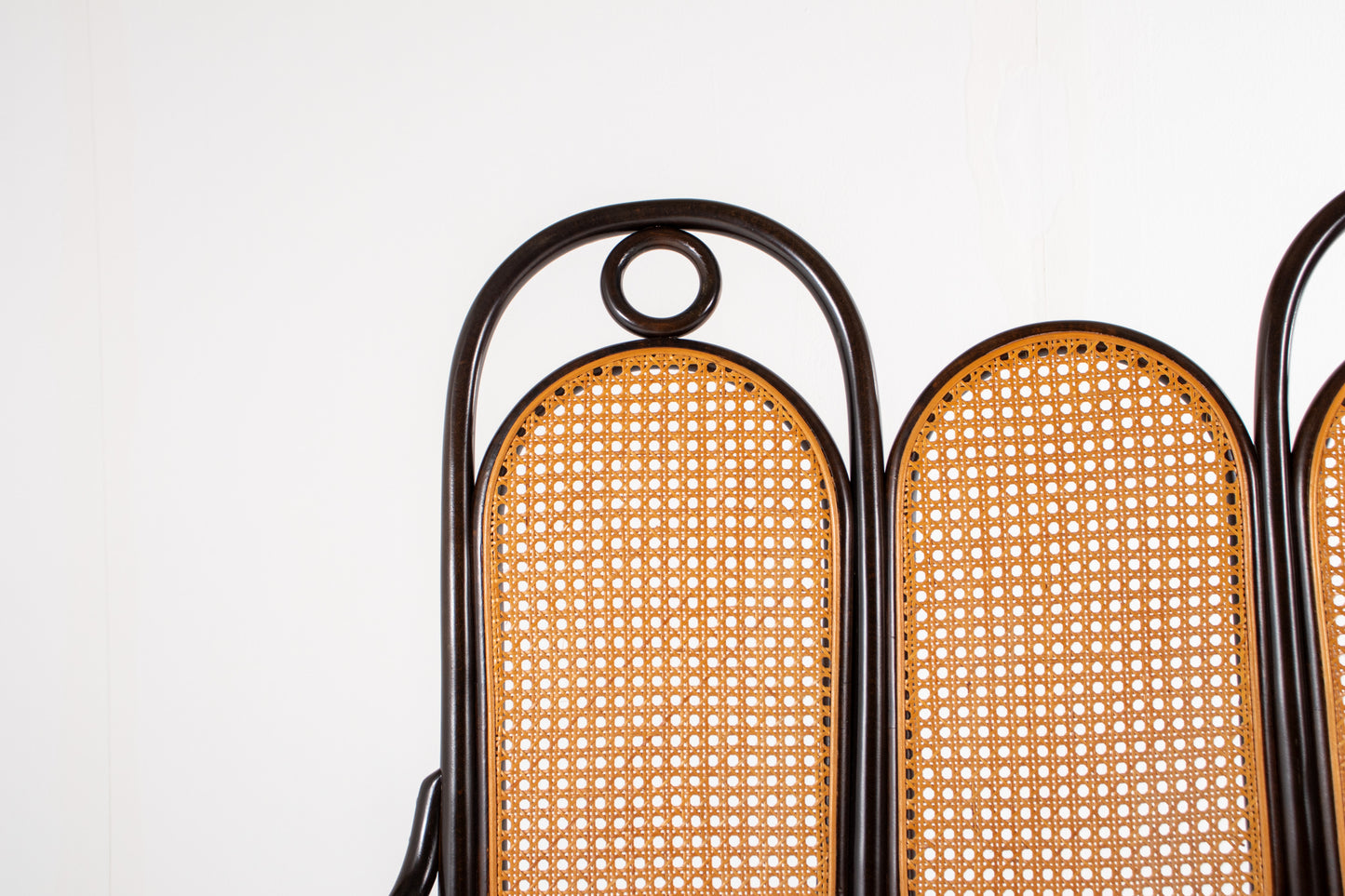 Bentwood bench with scroll arms and decorative rings, Thonet