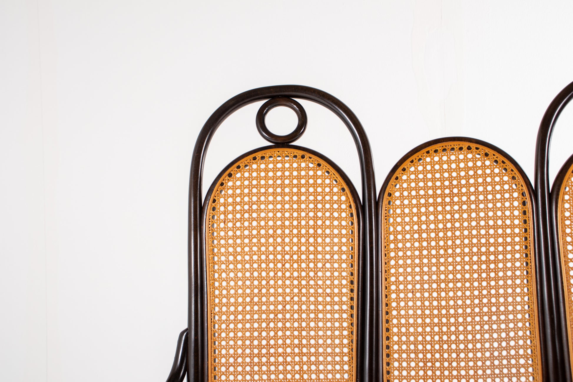 Bentwood bench with scroll arms and decorative rings, Thonet