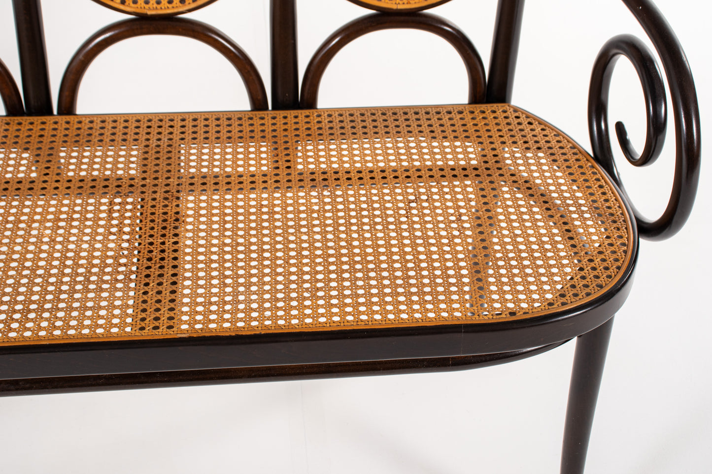 Bentwood bench with scroll arms and decorative rings, Thonet