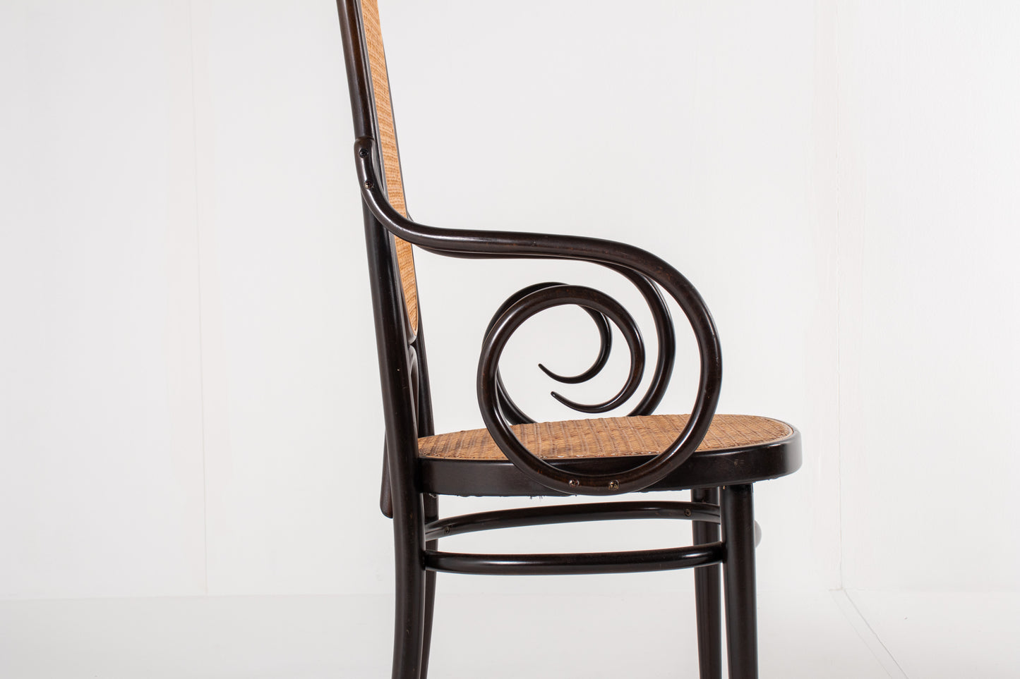 Detail of cane armrest on Thonet Model 17 chair
