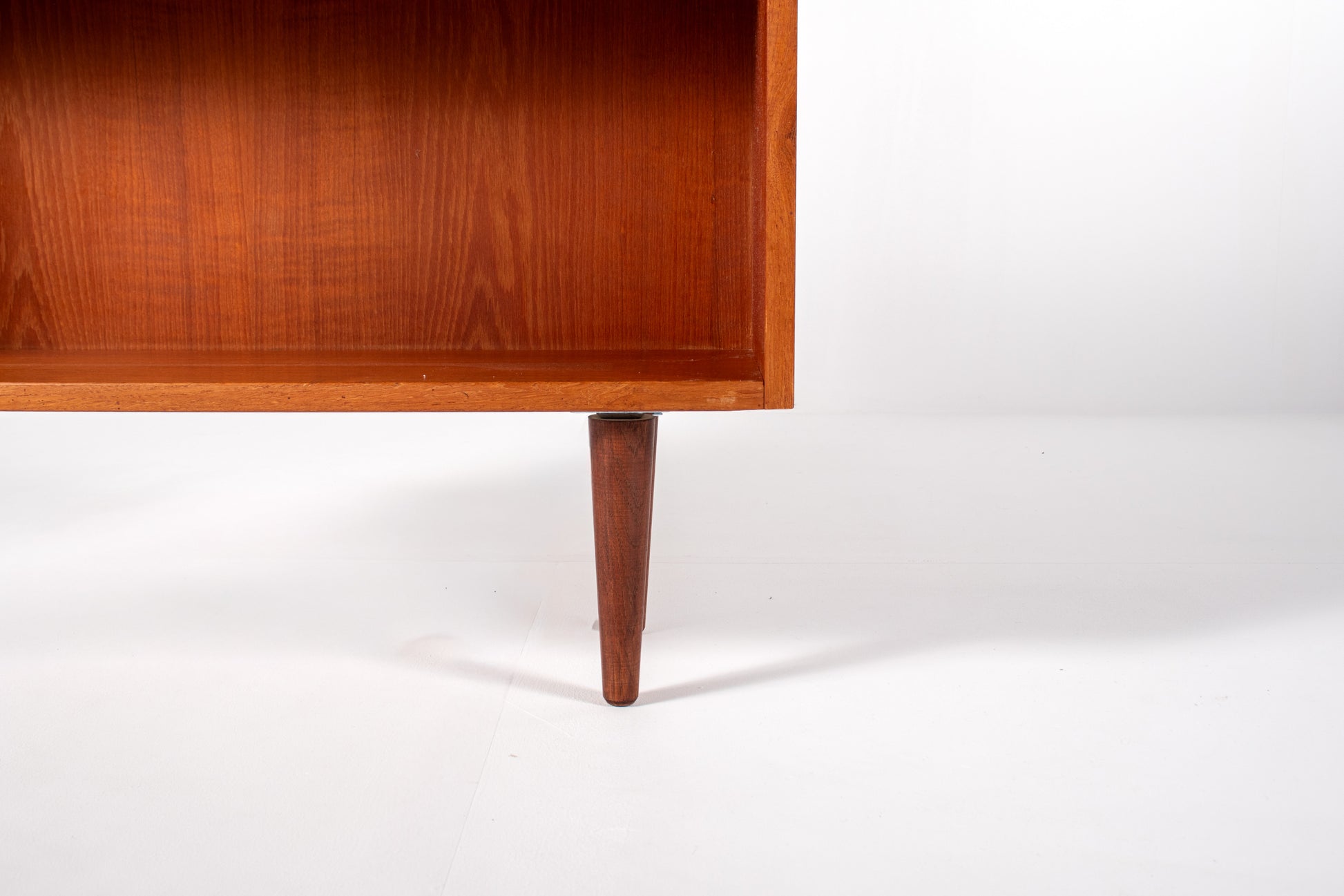 Tapered wooden legs on Danish mid-century modern teak bookcase
